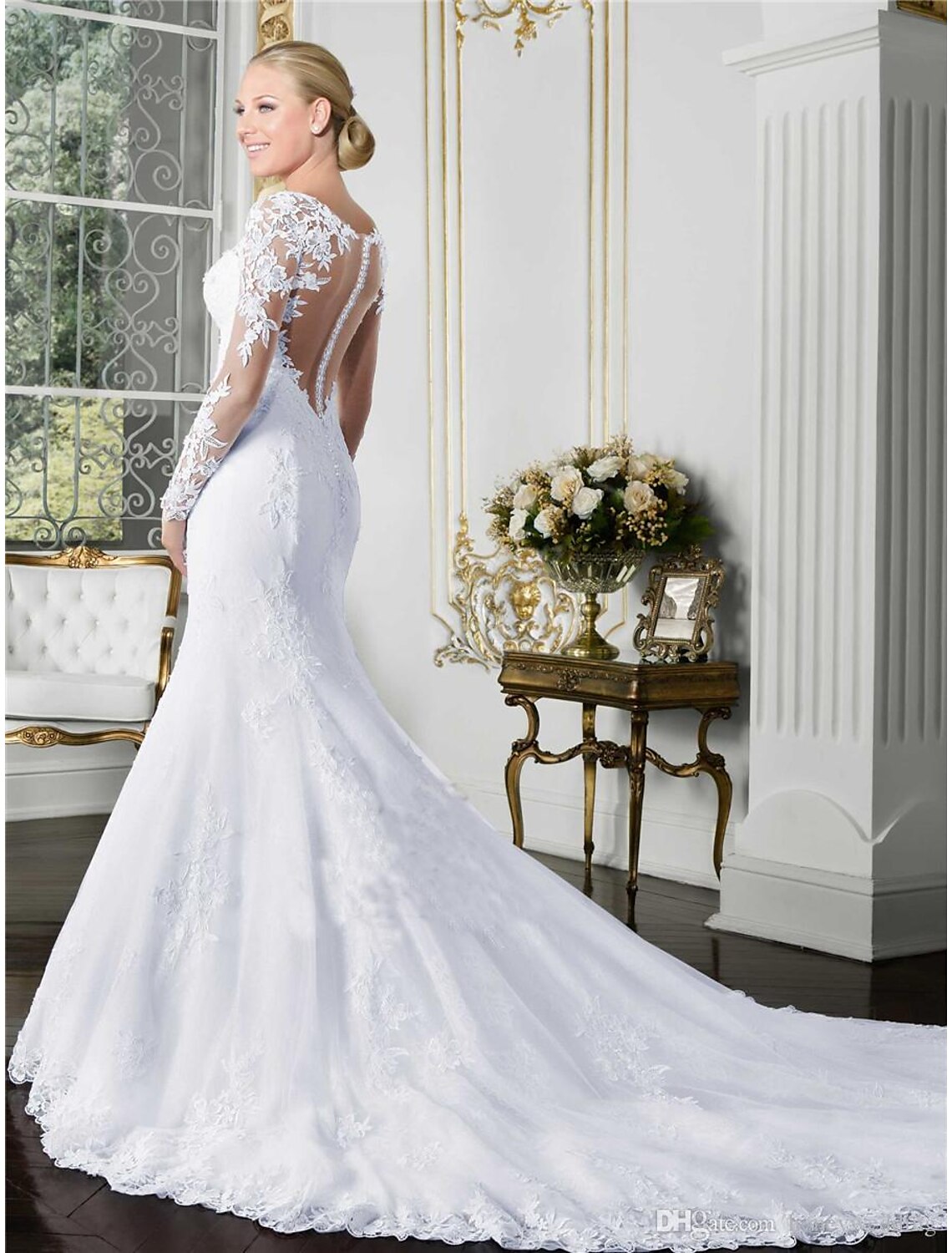 Bride wearing a white mermaid wedding dress with a flowing court train.