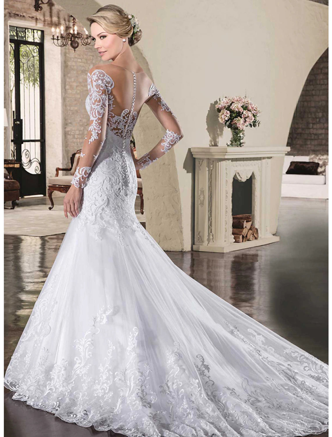 Front view of a model in the elegant lace bridal gown, highlighting the illusion neckline and long sleeves.