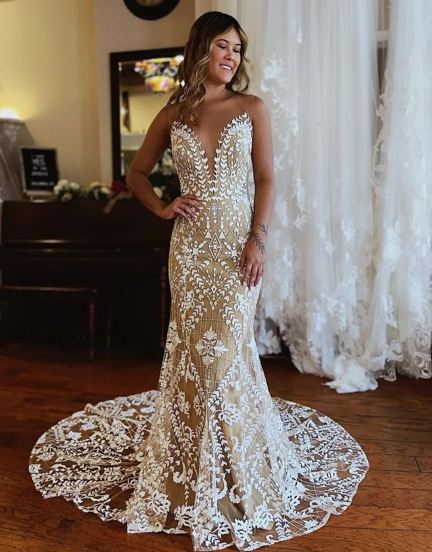 Dark champagne mermaid wedding dress with illusion neckline and lace details.