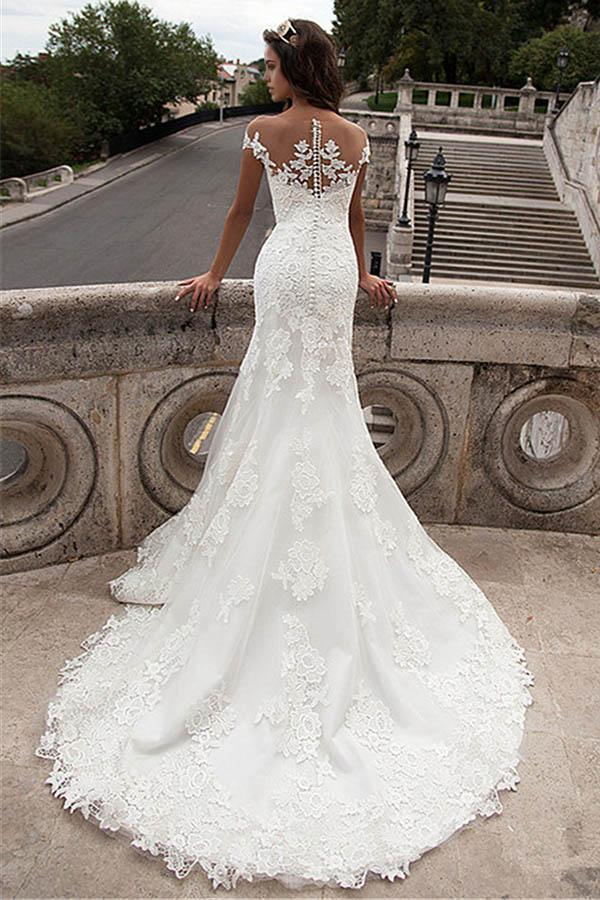 Mermaid wedding dress featuring intricate lace and an illusion neckline.
