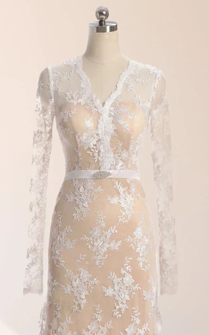 Side view of a woman wearing a mermaid long sleeve lace dress.