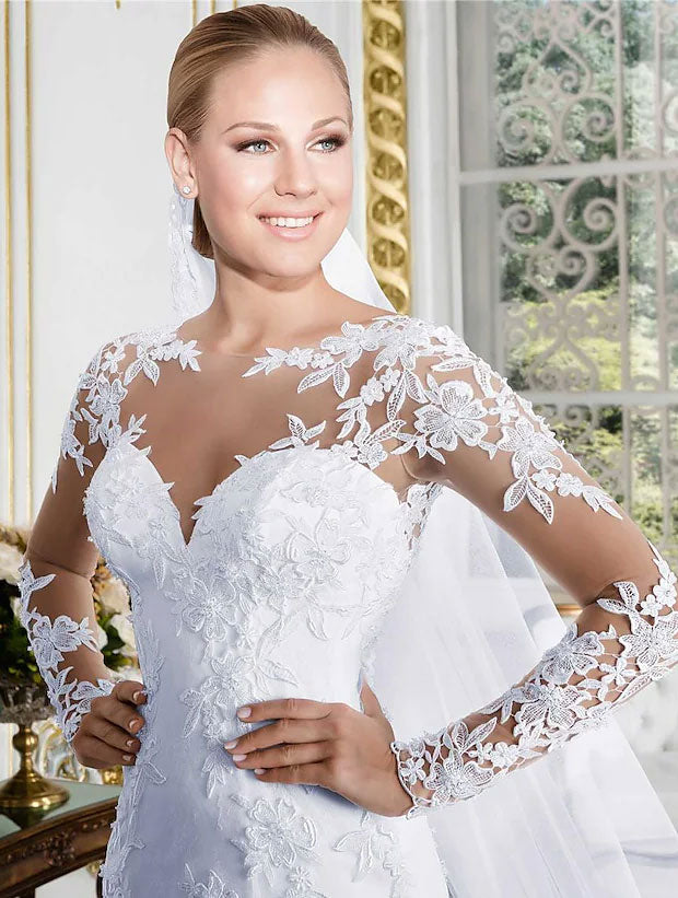 Close-up of the lace detail on a long sleeve wedding dress.