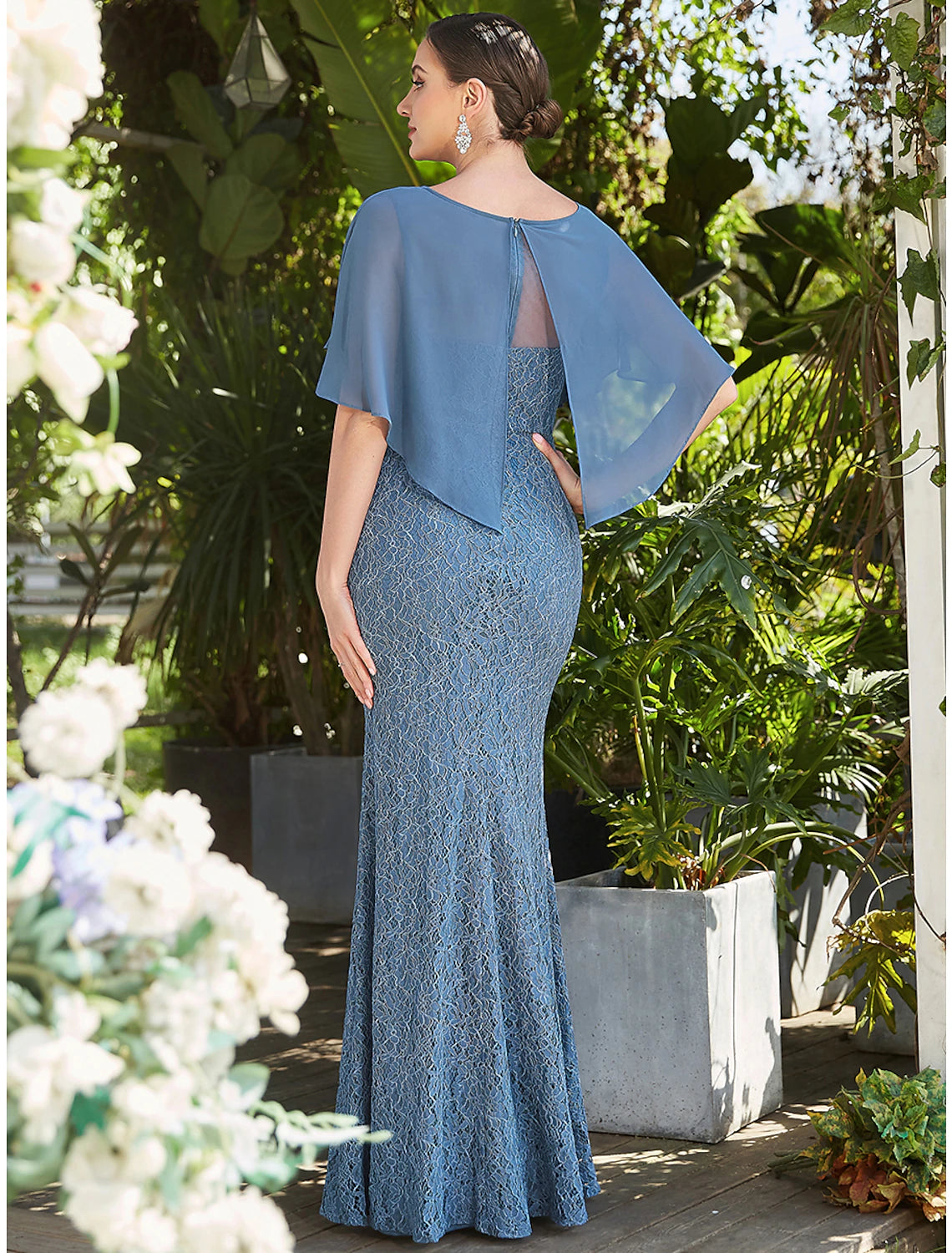 Side profile of a floor-length trumpet dress with appliques.