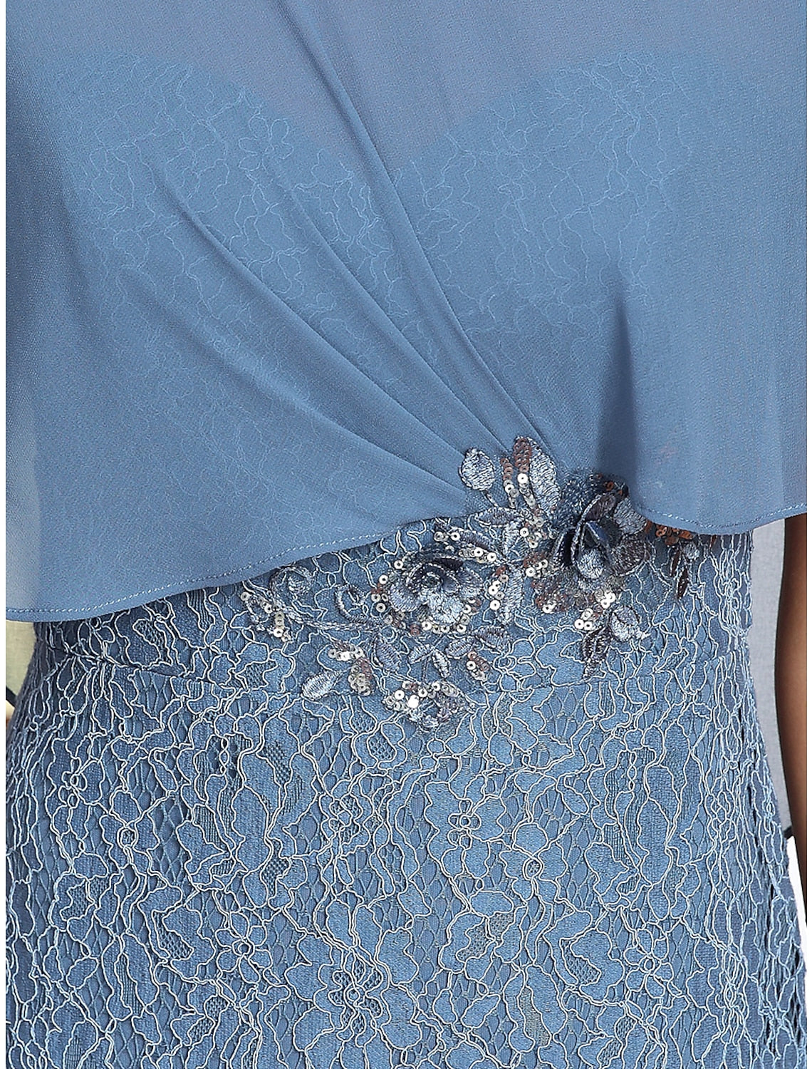 Close-up of lace and applique embellishments on a formal gown.
