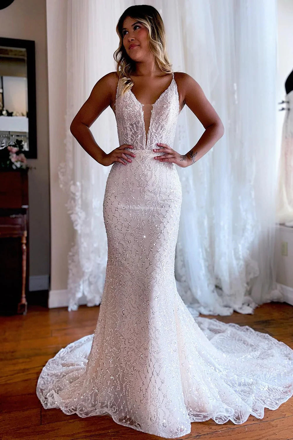 Elegant white mermaid lace wedding dress with a sweep train.
