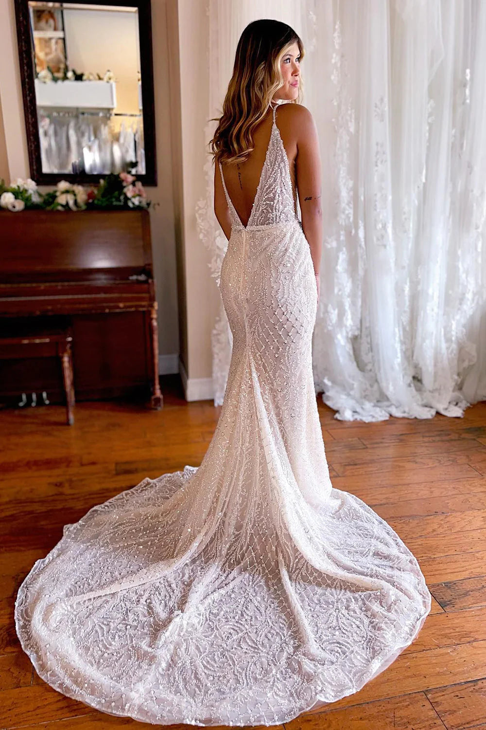 Backless detail of a white mermaid wedding gown with lace.