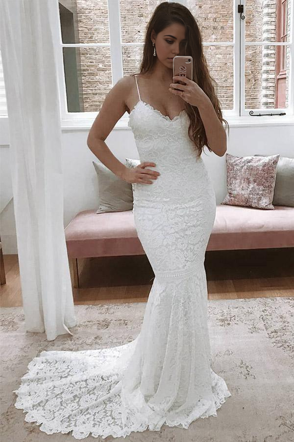 Elegant ivory lace mermaid wedding dress with spaghetti straps.