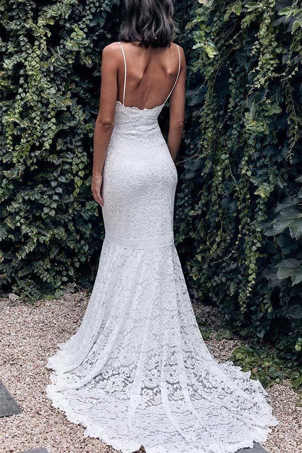 Close-up of the intricate lace detail on an ivory mermaid wedding dress.