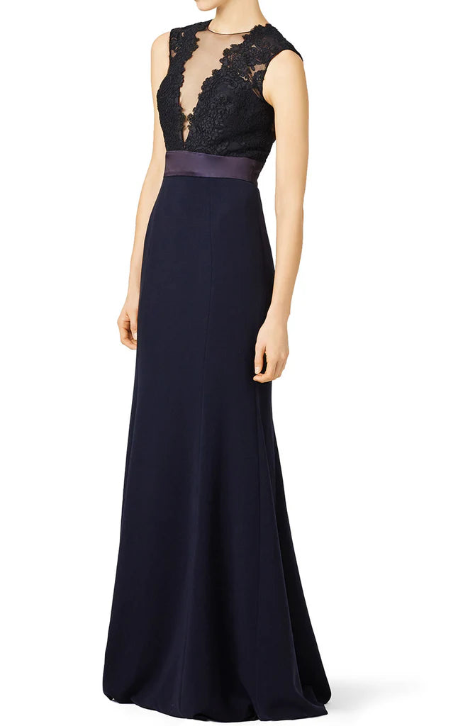 Side profile of a woman in a sleeveless mermaid dress with intricate lace details.