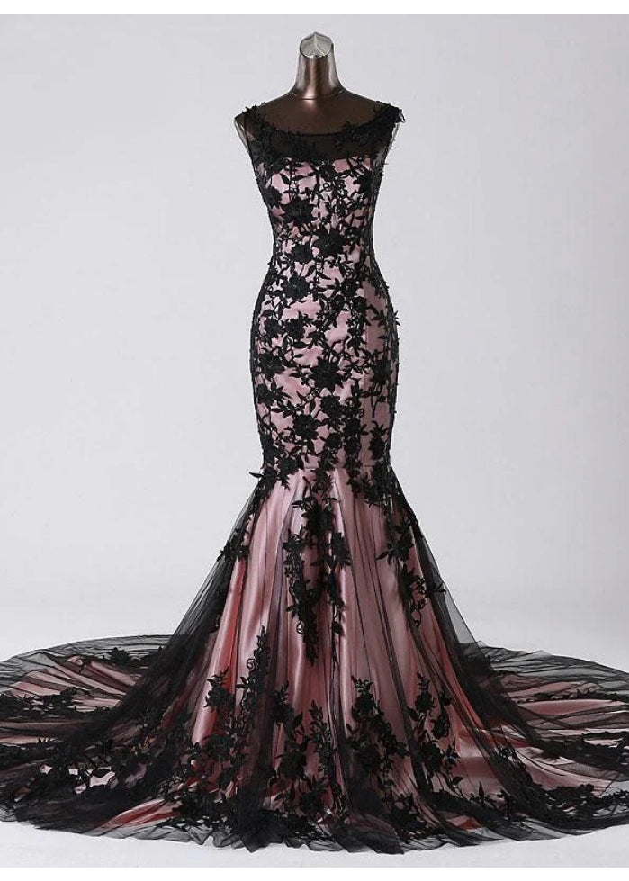 Elegant mermaid lace sleeveless prom dress on a model.