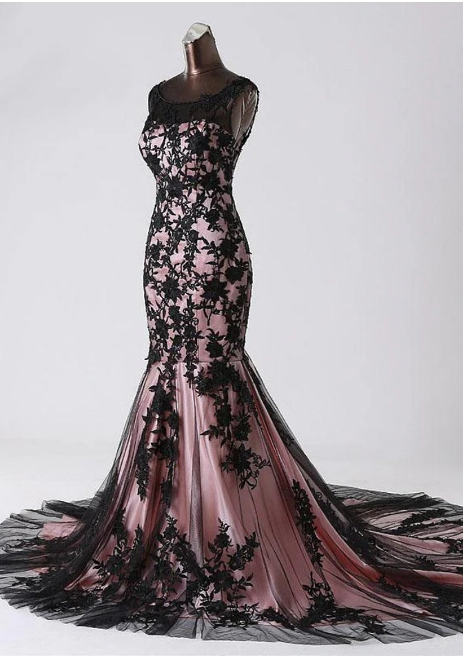 Back view of a mermaid lace sleeveless evening gown with intricate detailing.