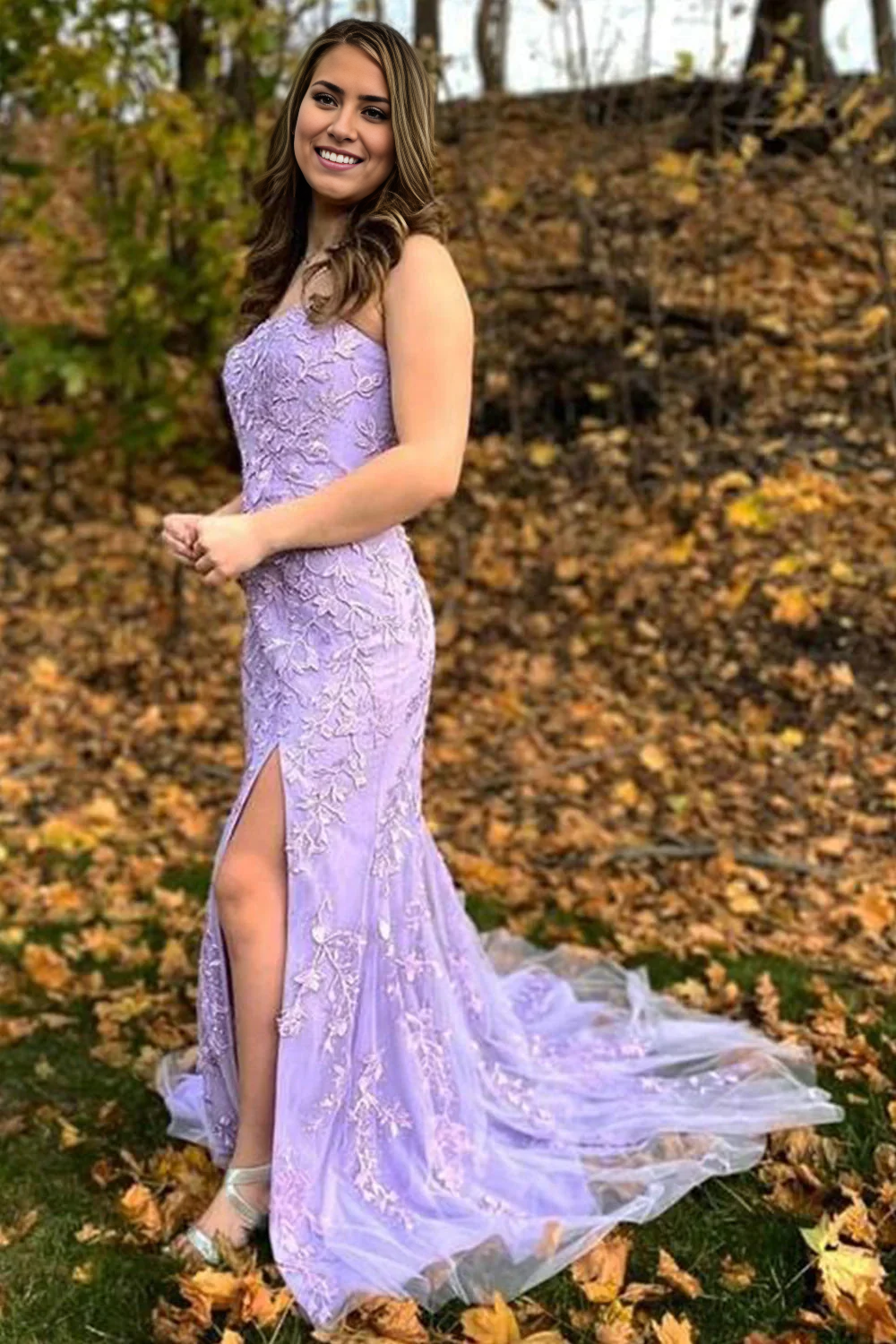 Side view of the long prom dress, highlighting the lace and slit.