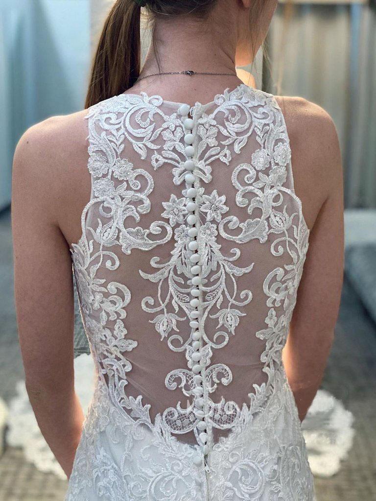 Side view of mermaid lace wedding dress with long train.