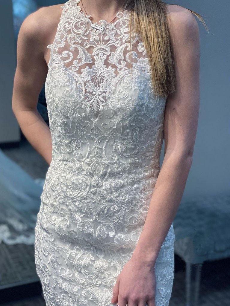 Back view of mermaid lace wedding gown showing racer back and train.