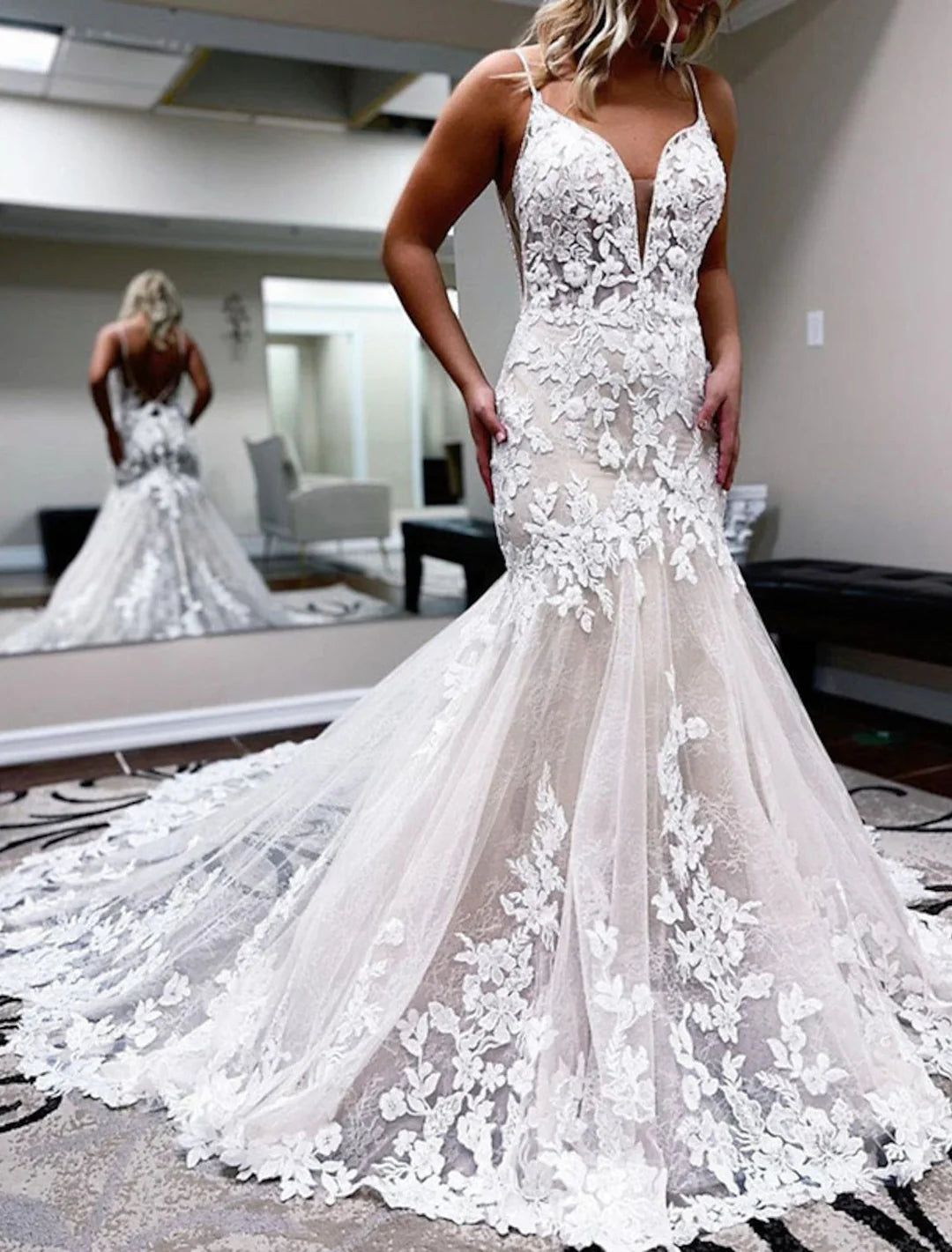 Elegant mermaid lace wedding dress with spaghetti straps, front view.