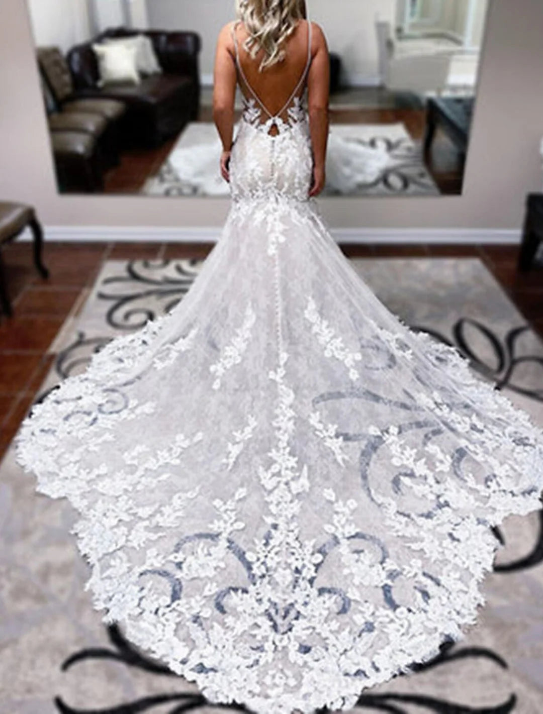 Back view of a mermaid lace wedding dress with delicate spaghetti straps.