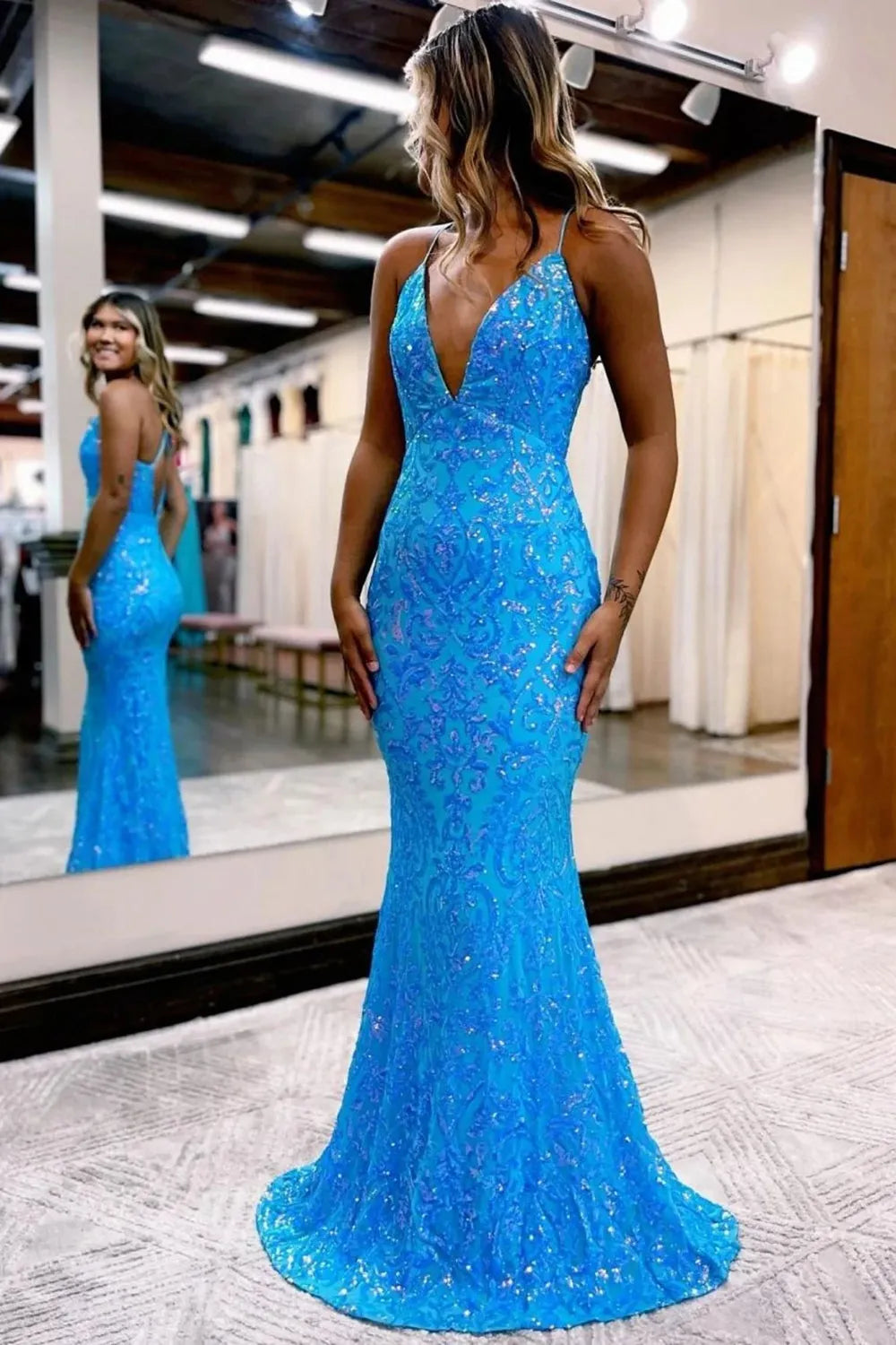 Elegant mermaid prom dress with spaghetti straps and intricate appliques.