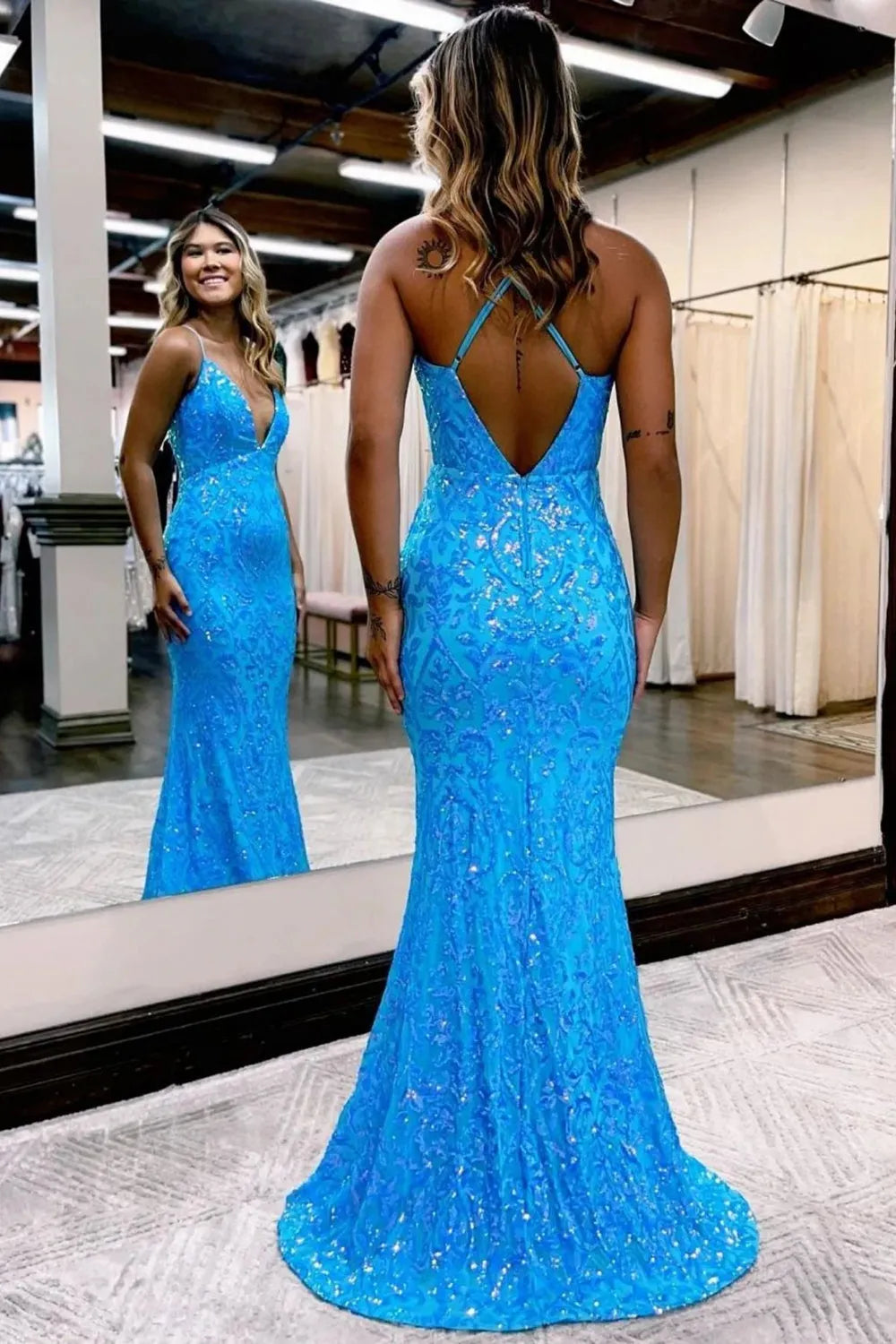 Back view of a long mermaid prom dress featuring delicate appliques.