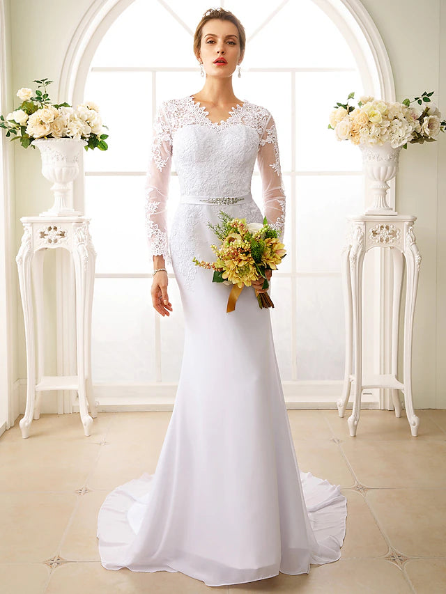 Elegant mermaid wedding dress with long illusion sleeves and open back.