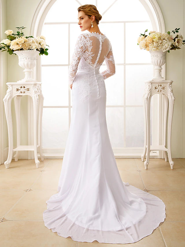 Back view of a mermaid wedding gown showing court train and appliques.