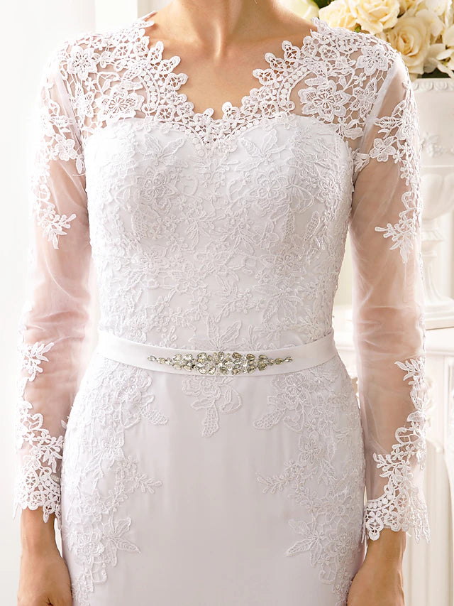 Close-up of the illusion neckline and long sleeves on a bridal gown.