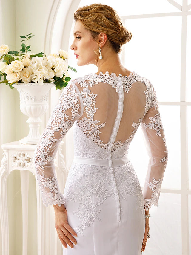 Bride wearing a long sleeve mermaid wedding dress.