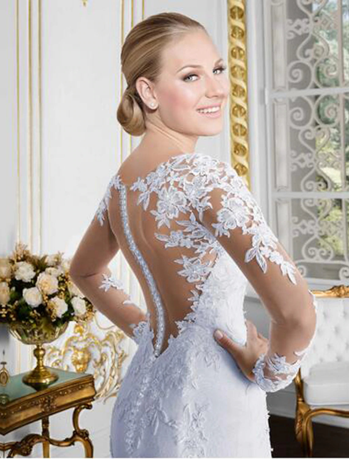 Full view of bridal gown with chapel train and illusion neckline.