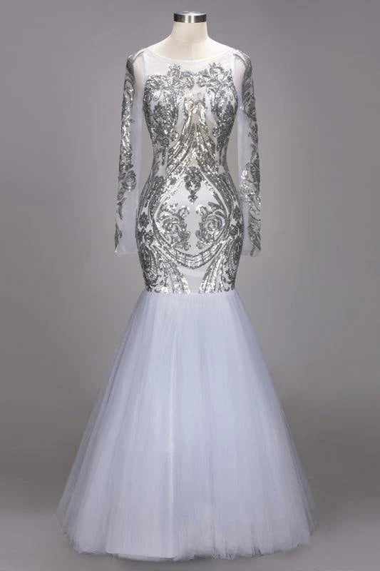 Model wearing a sequined tulle mermaid prom dress with long sleeves.