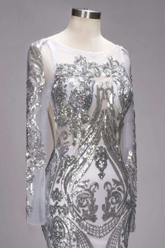 Model posing elegantly in a shimmering long sleeve mermaid dress.