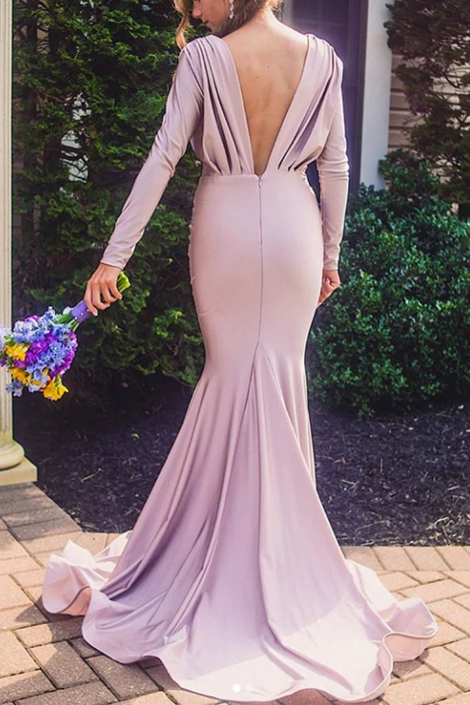 Rear view of a woman in a long sleeve V-neck mermaid formal dress, showcasing the elegant back.