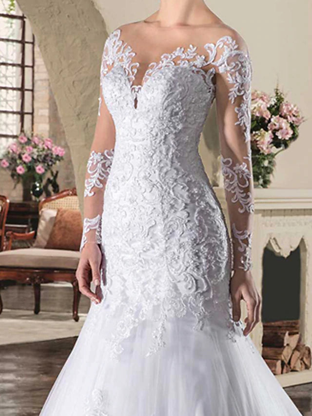 Side profile of the bridal gown, highlighting the court train and lace details.