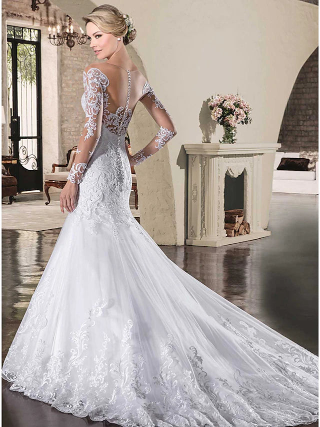 Close-up of the illusion neckline and intricate lace appliques on the wedding dress.