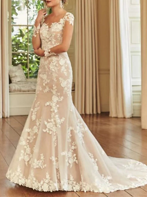 Model wearing an elegant white mermaid long sleeve wedding dress with a court train.