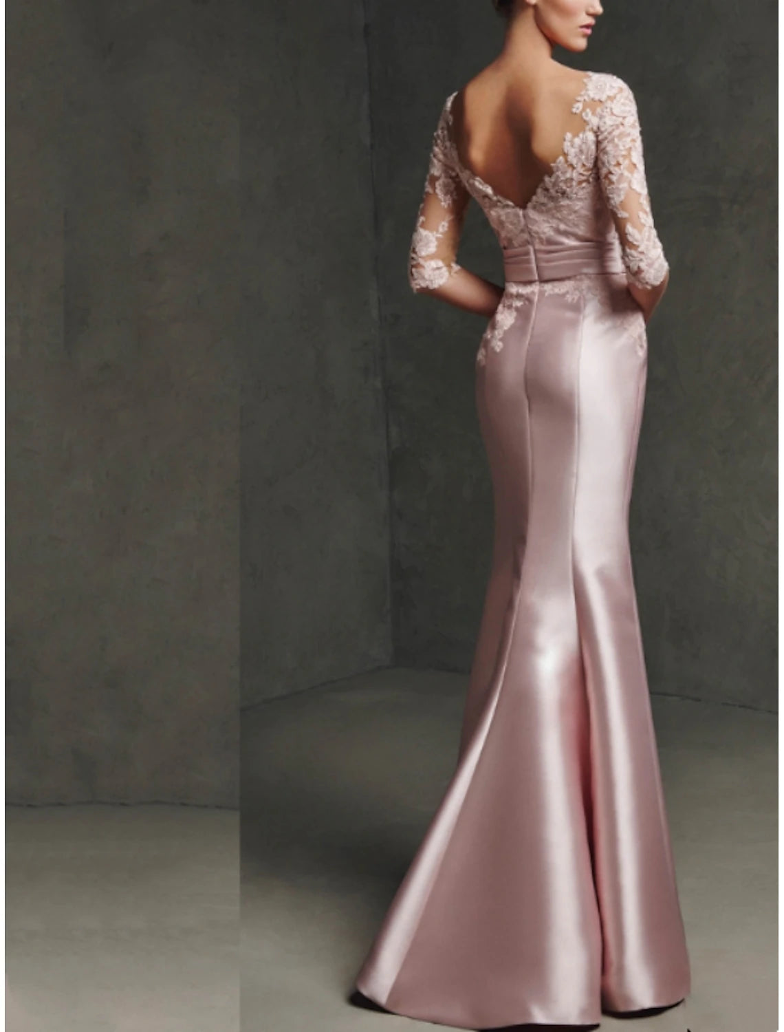 Back view of a sophisticated Mermaid Mother of the Bride gown with a split front and pleats.