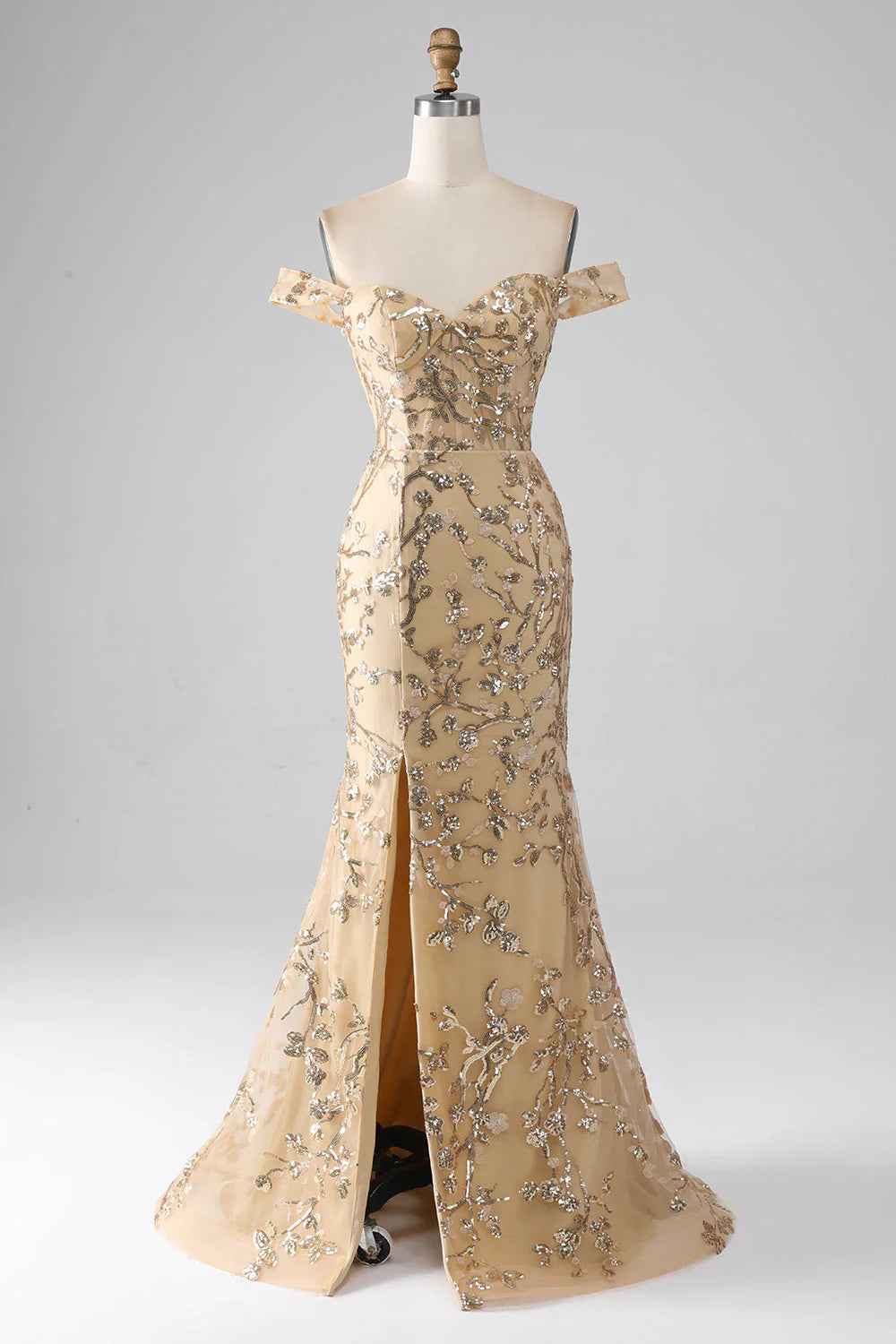 Woman wearing a golden mermaid off-shoulder beaded prom dress with a thigh-high slit.