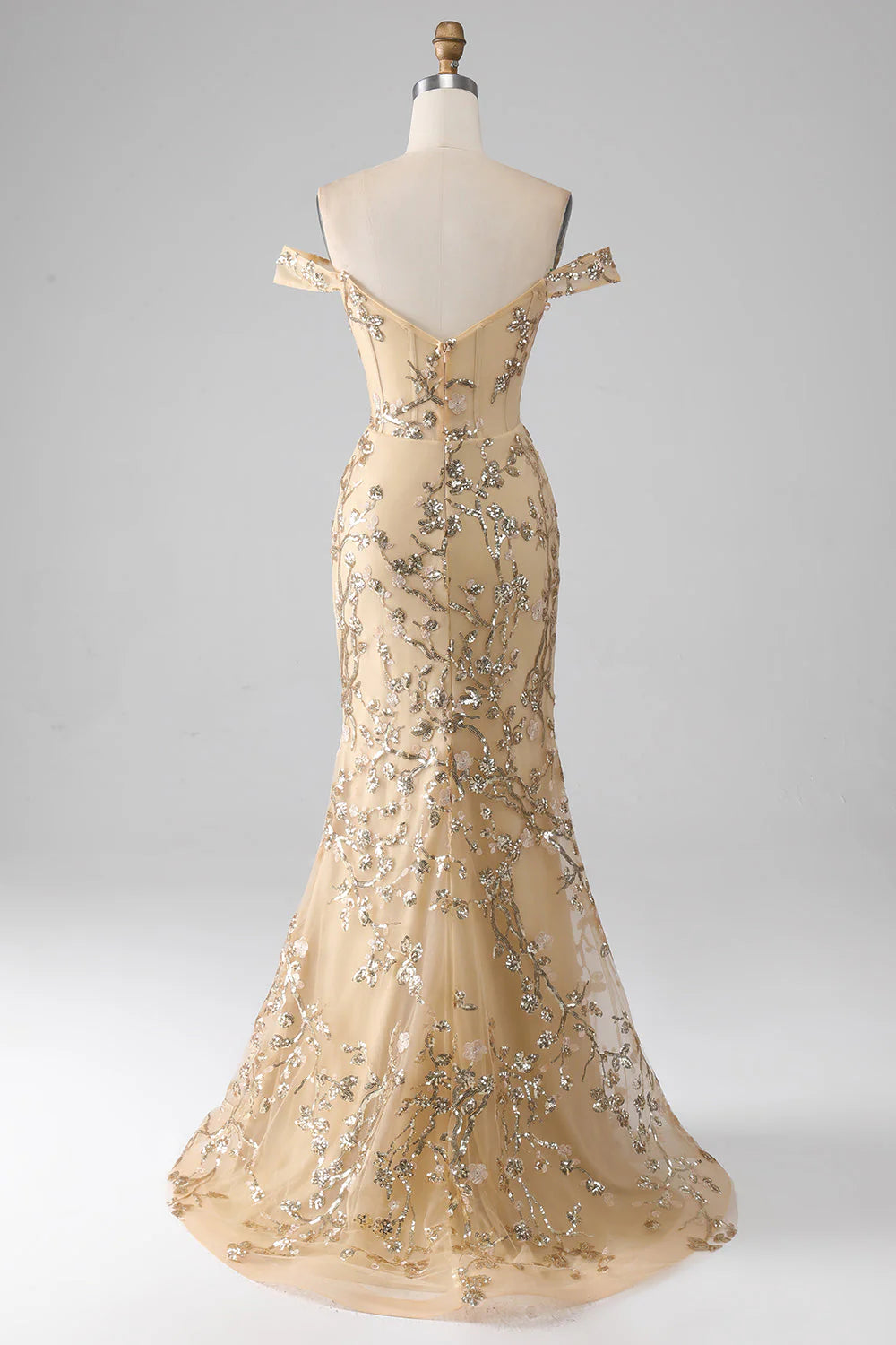 Back view of a woman in a golden mermaid off-shoulder beaded long dress.