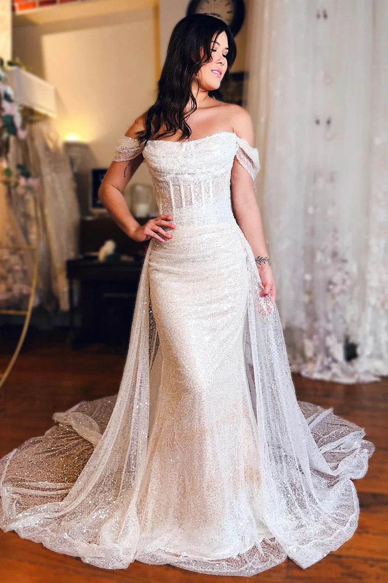 Elegant mermaid off-shoulder wedding dress with a flowing train.