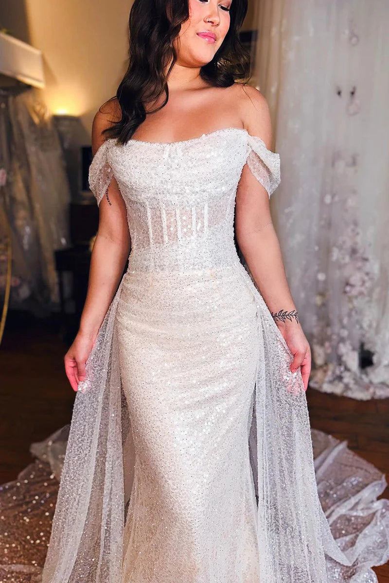 Back view of a mermaid off-shoulder bridal gown, showcasing its silhouette.