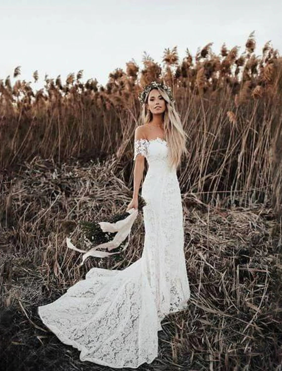 Close-up of the off-shoulder lace and applique details on the bridal gown.