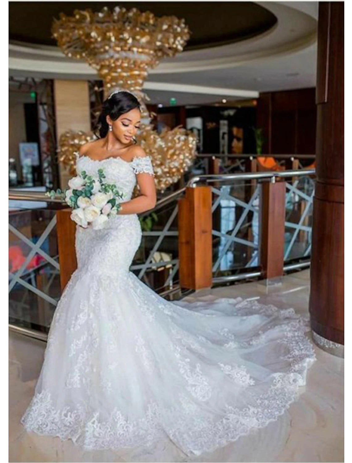 Elegant mermaid wedding dress with off-shoulder neckline and lace appliques.