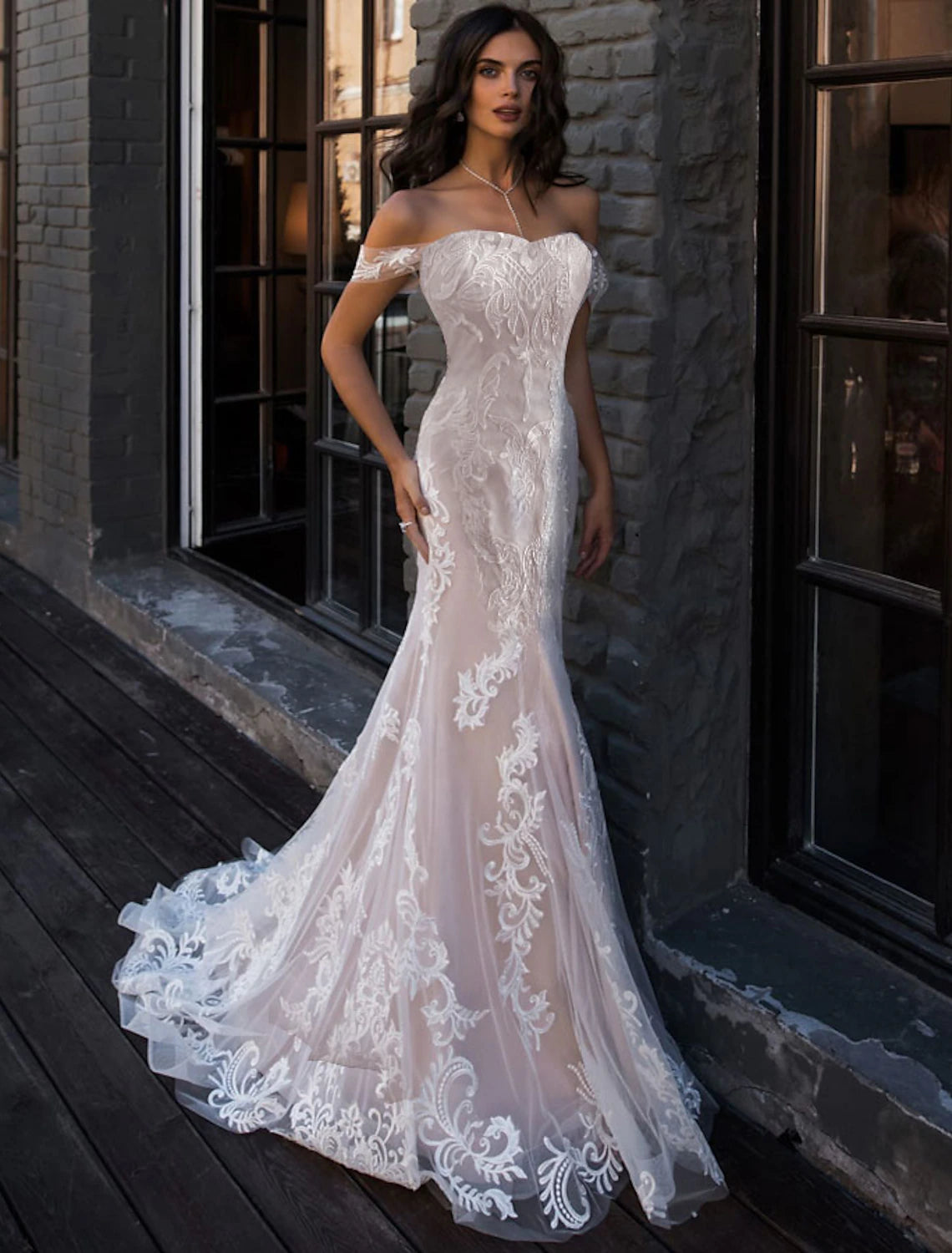 Back view of a beautiful Lace Mermaid Wedding Dress with a flowing court train.