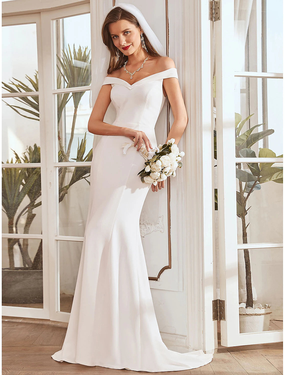 Elegant mermaid off-shoulder cap sleeve wedding dress with pleats and draping.