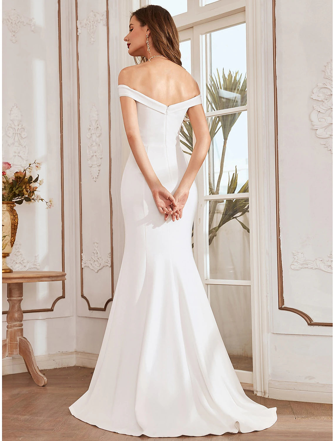 Side view of a mermaid off-shoulder cap sleeve wedding dress.