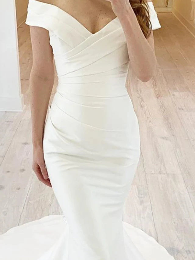 Back view of a long chiffon satin mermaid wedding gown.