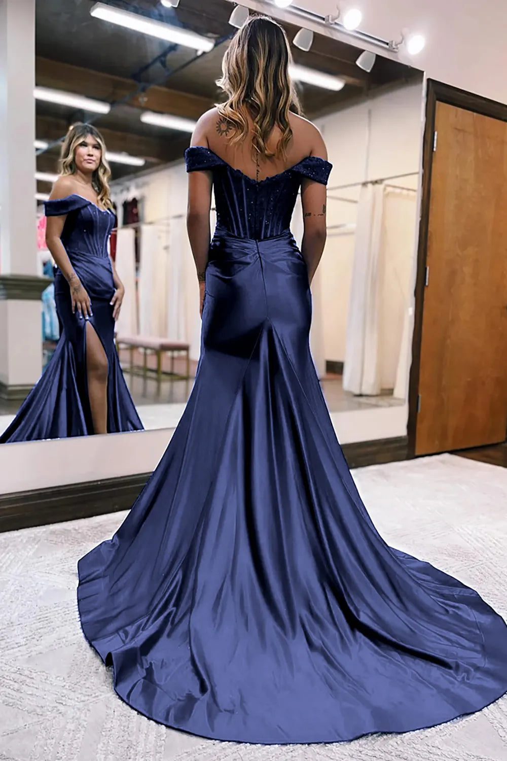 Back view of the dark navy mermaid dress, showing the elegant court train.