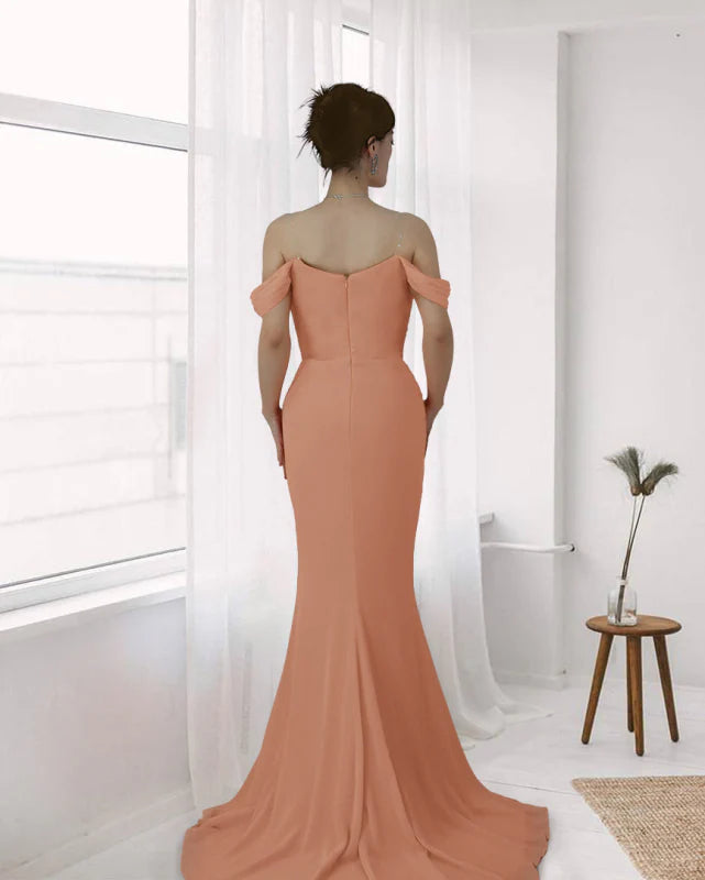 Woman posing in a long off-shoulder formal evening gown.