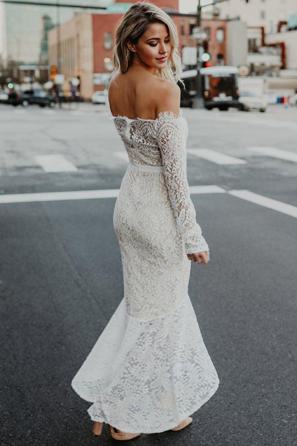 Close-up of delicate lace details on a wedding dress.