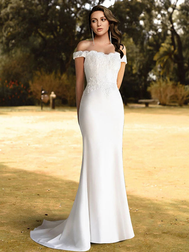 Elegant mermaid off-shoulder wedding dress with lace appliques and sweep train.