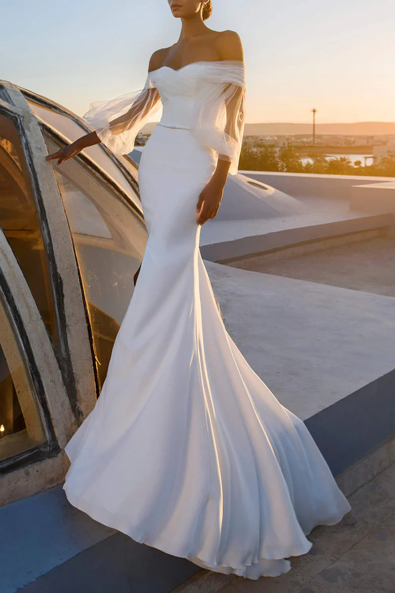Elegant mermaid off-shoulder long sleeve wedding dress, front view.