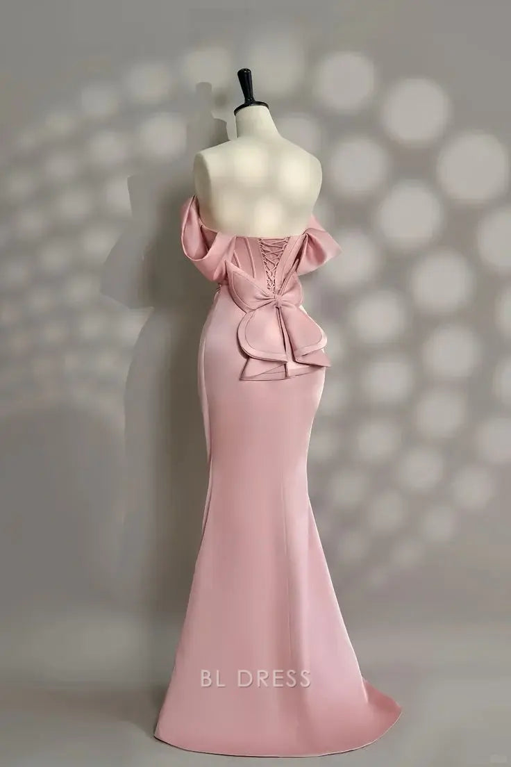 Elegant pink mermaid off-shoulder gown with pearl beading.